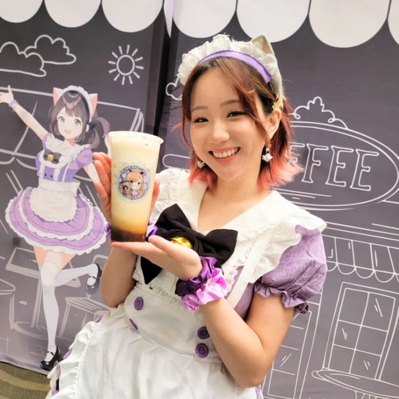 Maid Arana holding a milk tea bubble drink from Maid Cafe in Los Angeles
