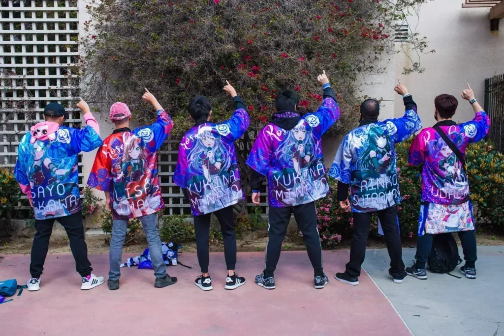 The Arcane Maid Café team in matching jackets at an outdoor event