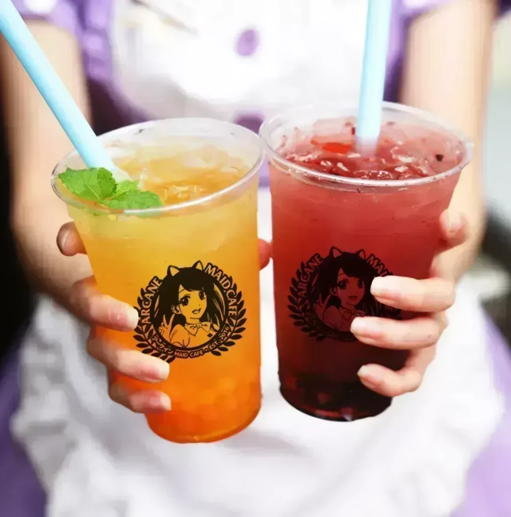 Two bubble drinks with the Arcane Maid Café logo