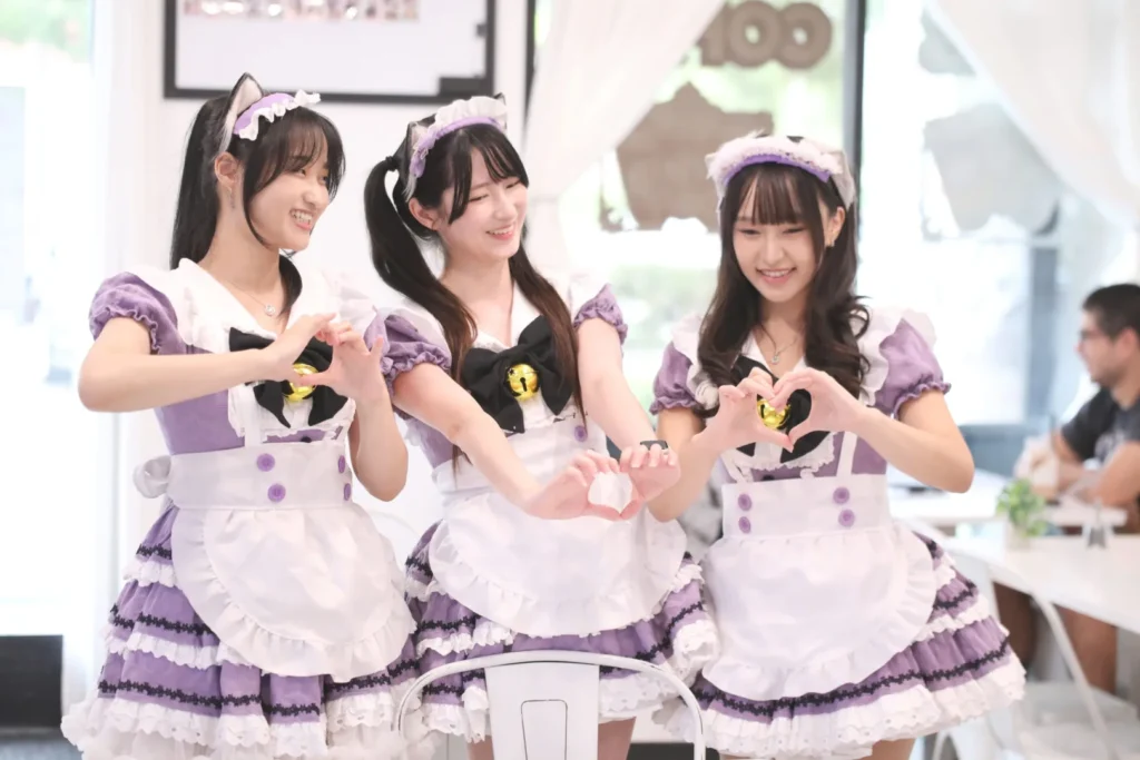 Three Arcane Maid Café maids making heart hands