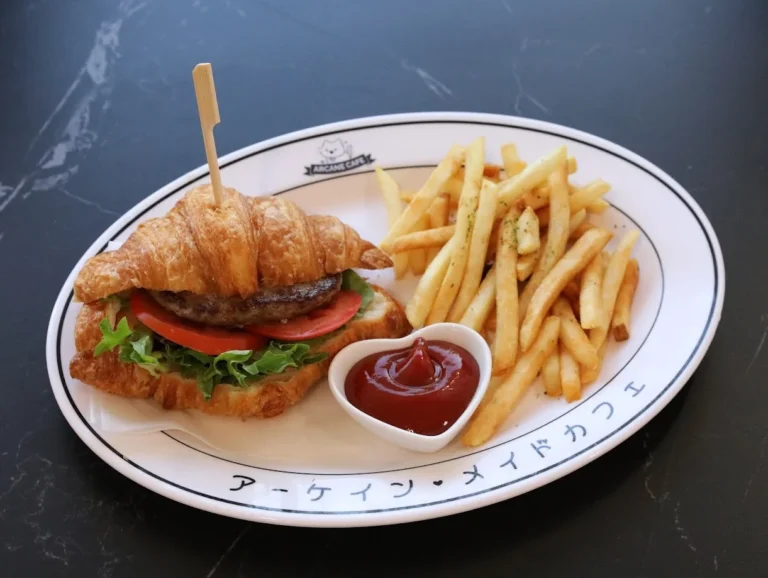 Croissant burger with fries on an Arcane Maid Café plate